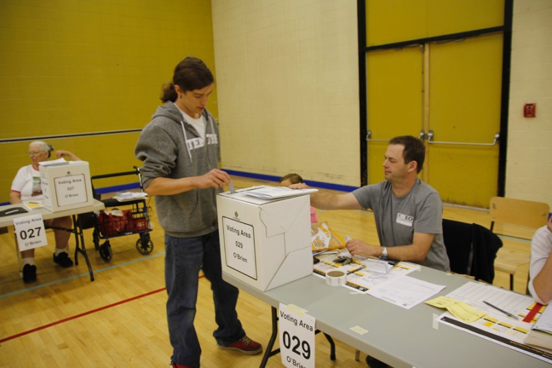 Photo by stock photo -- A voter readies his ballot at O'Brien Centre on Tuesday.