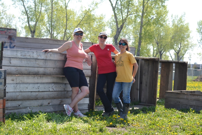 Photo by Carl BR Johnson -- Michelle LaBoucane and Leah Stewart with another volunteer of the community gardens hopes that this site near the Church of the Resurrection will be their final home, as they have moved three times in 10 years.