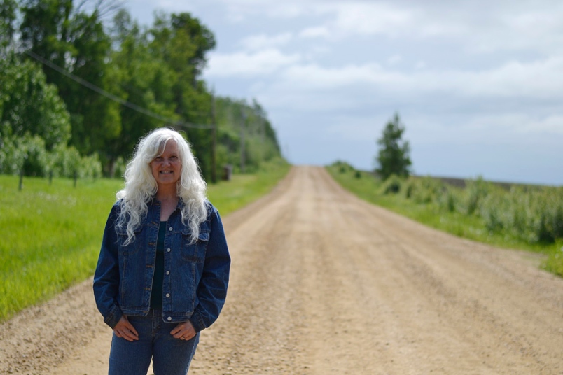 Photo by Carl BR Johnson -- Trina Commandeur stands on Road 237 where noise from ATVs has been disturbing her family into the early hours of the morning.