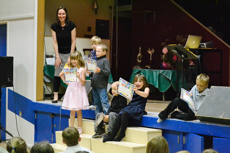 Photo by Carl BR Johnson -- Principal Joanne Dueck stands with her kindergarten students as they receive awards for completing their kindergarten class.